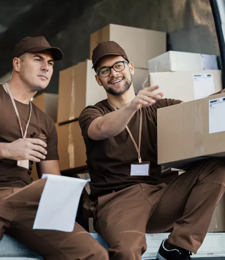 Movers sitting in a van with boxes